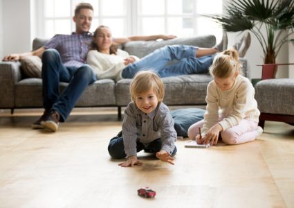 Cute,Kids,Playing,While,Parents,Relaxing,Sofa,At,Home,Together, For homes